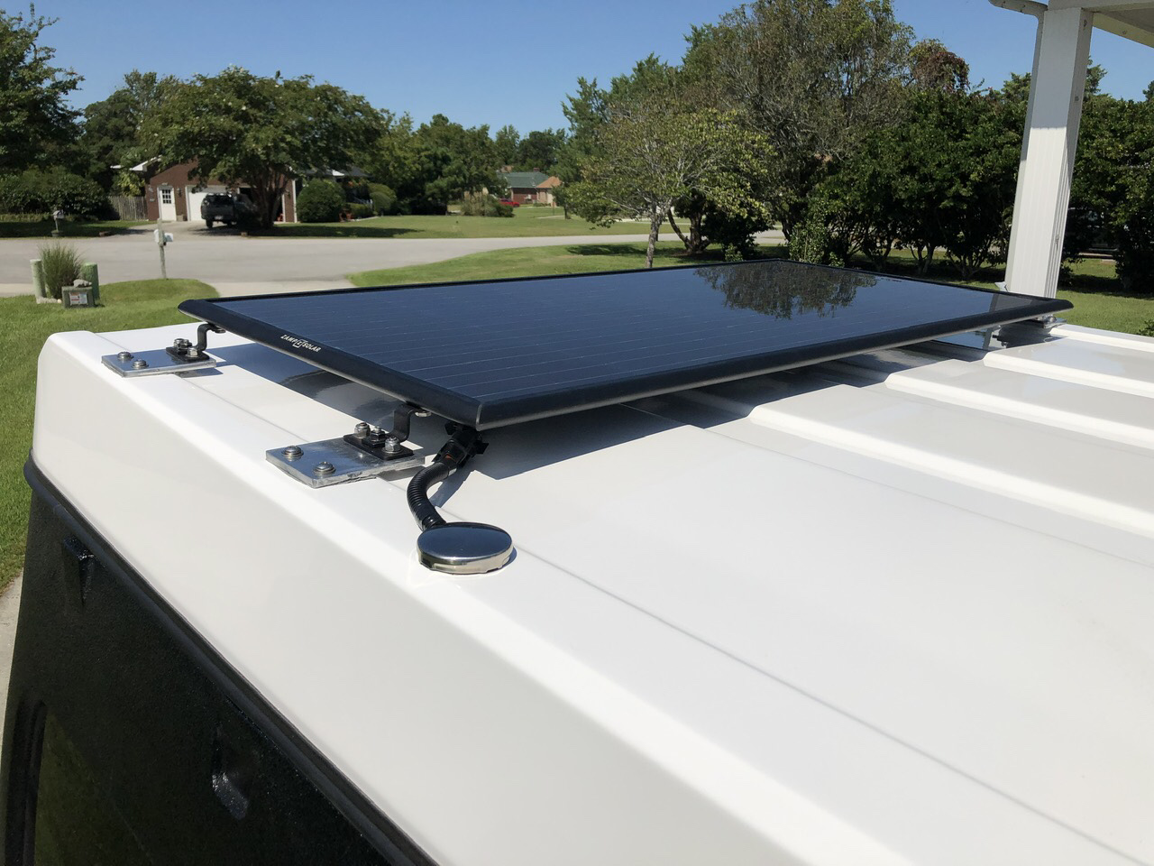 The obsidian panel mounted on the Jeep. It's thin for a rigid panel. Has a 25 year warranty snd made in the USA.