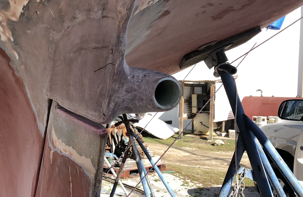 An abrupt termination of the trailing end to the port side of the shaft log.